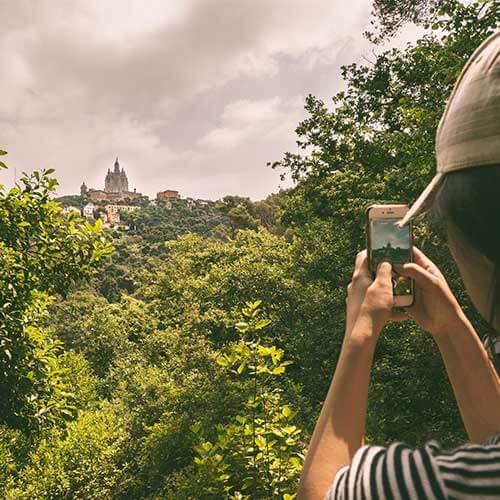 Student taking a photo of Tibidabo from afar